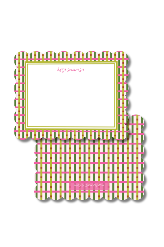 A decorative notepad sheet with a scalloped border and a plaid pattern in pink, green, and white, featuring a blank writing area and a small pink label at the bottom.